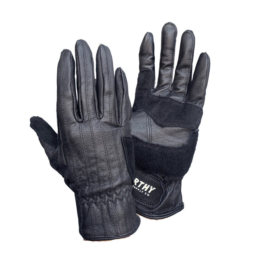 A pair of brown and yellow leather gloves with visible stitching and the brand name 'NORTHY' on the wrist strap.